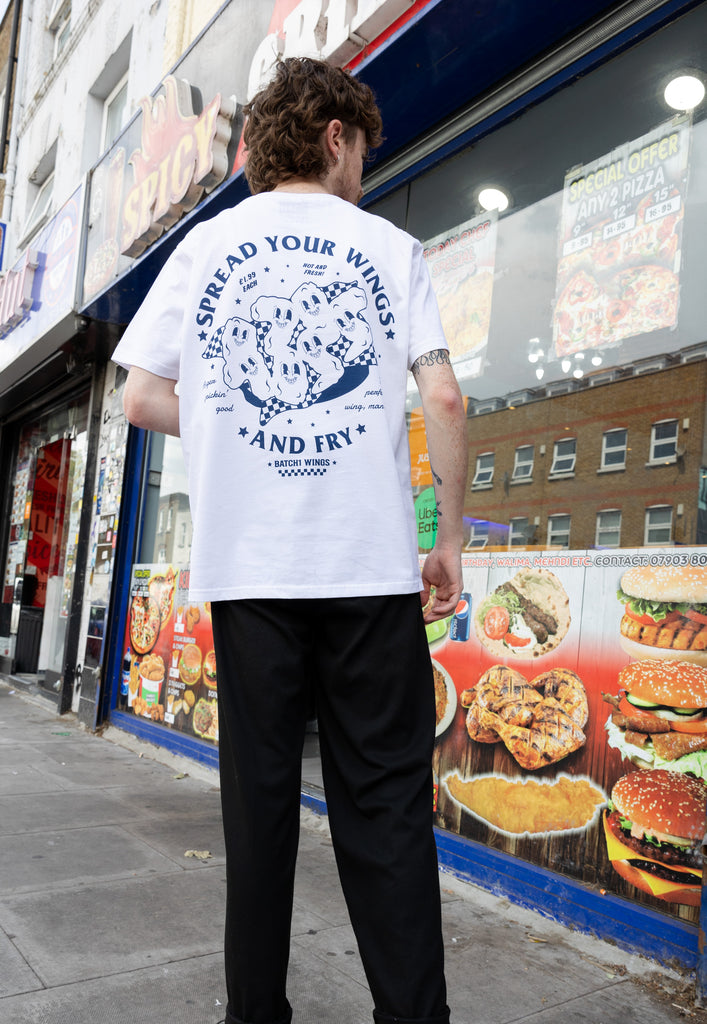 large back spread your wings and fry graphic tee model shoot in front of chicken shop