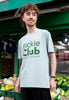 Model wears green text pickle club slogan tshirt in dusty green