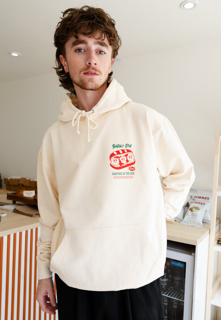 Model wears vanilla hoodie with small front print logo