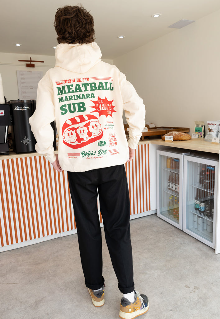 Model wears vintage style printed graphic hoodie in vanilla