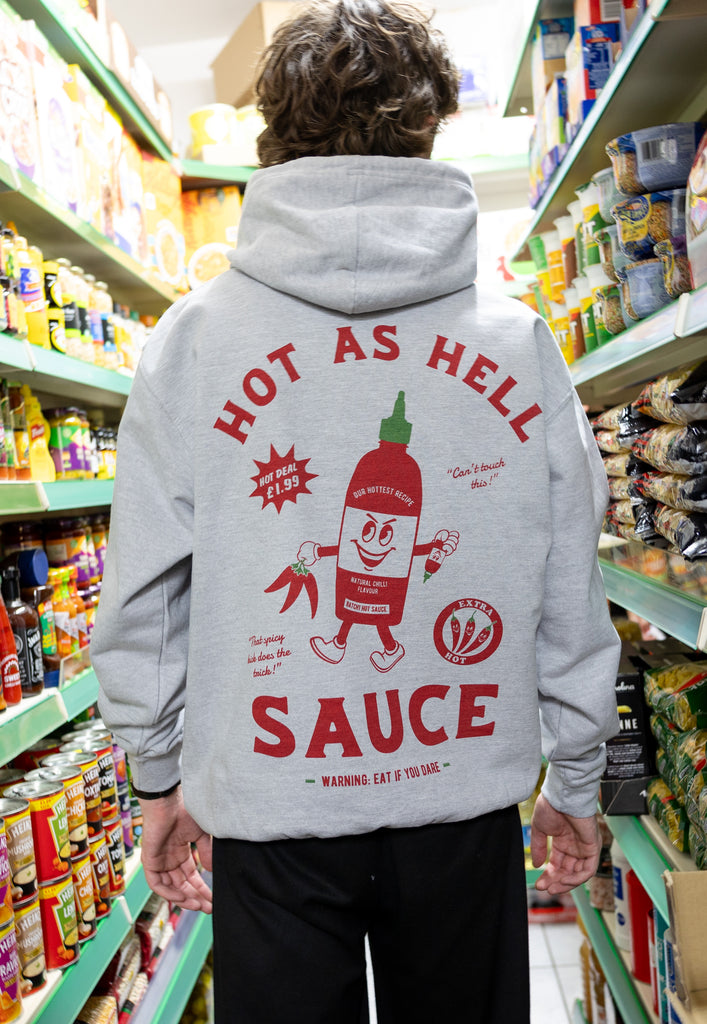 male model wears grey hoodie with large hot sauce logo graphic back print