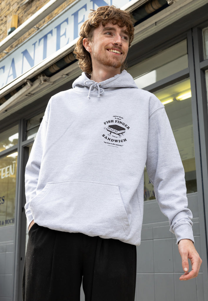 Model wears small front fish finger logo hoodie in grey