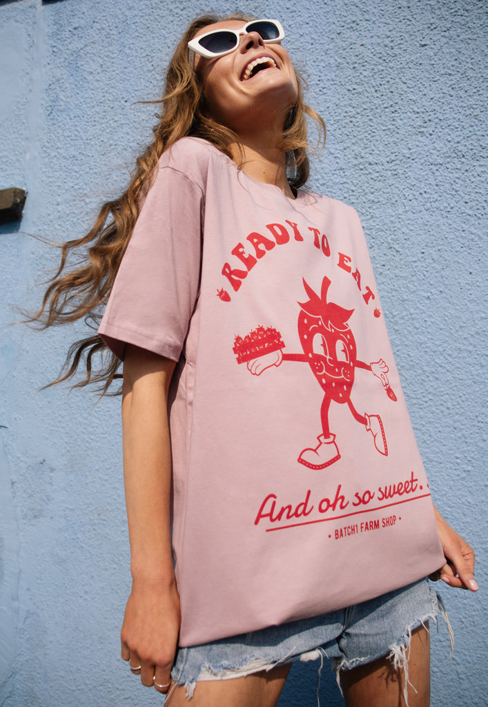 model wears pastel purple summer t shirt with strawberry character