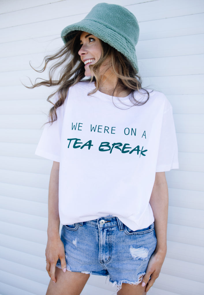 Model wears white tshirt with We Were on a Tea Break slogan 