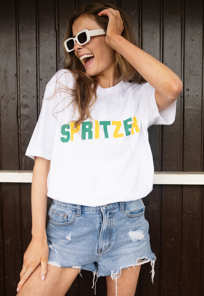 Model wears white tshirt with Spritzer slogan