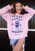 Model wears pink sweatshirt with berry smooth printed graphic 