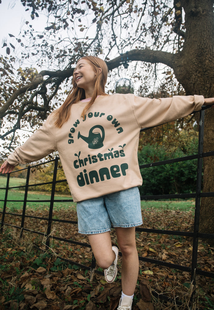 sustainable christmas jumper with grow your own slogan and graphics in green print