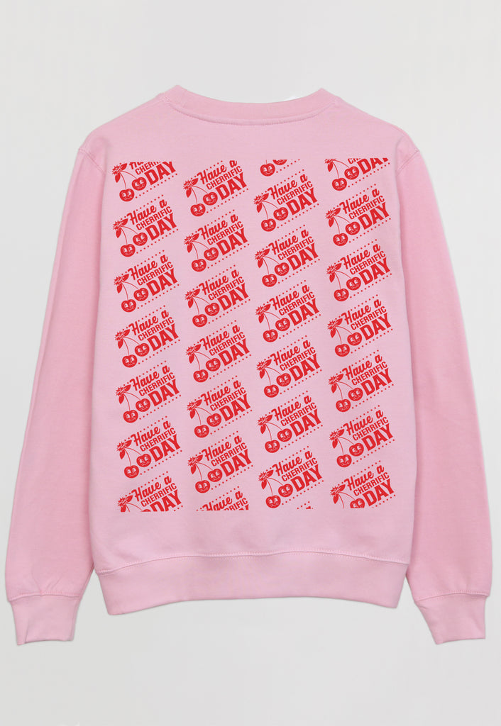 flatlay of pink sweatshirt showing repeated cherry logo in red print on back of garment