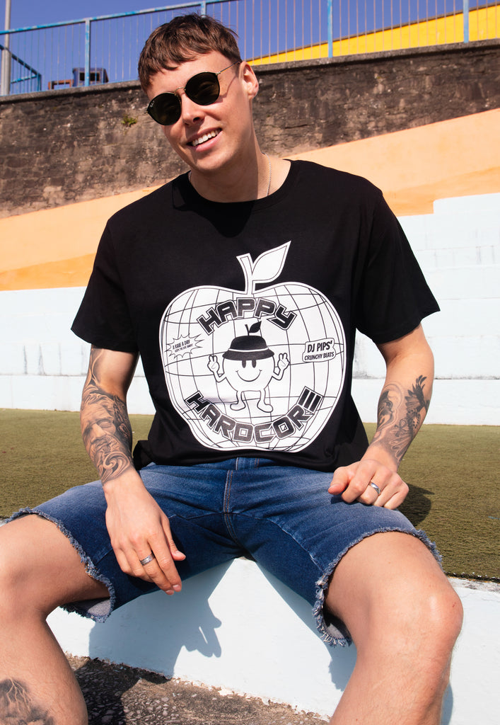 Male model is wearing black t-shirt with printed apple logo and happy hardcore slogan in white on front of top