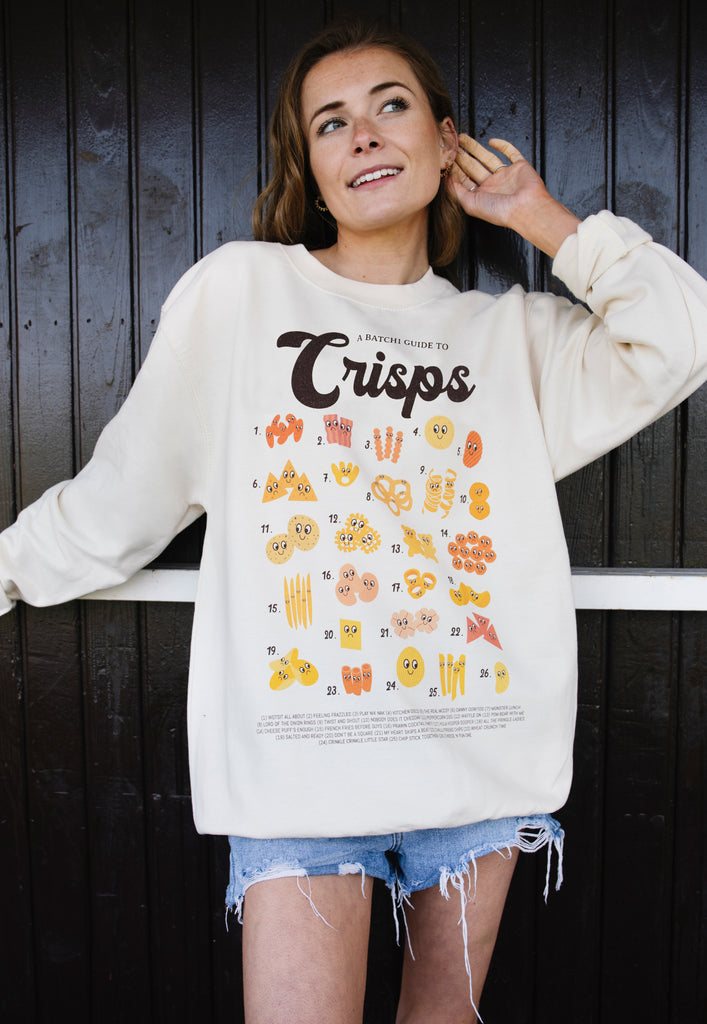 Model wears vanilla sweatshirt with printed Crisps guide and fun crips character graphics