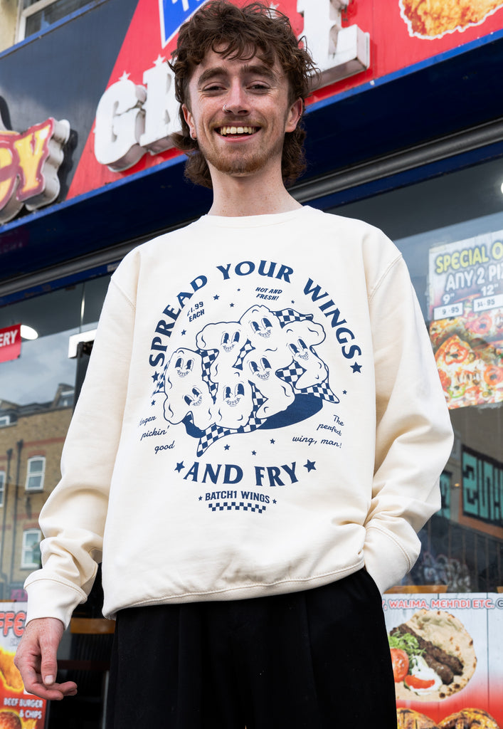 model wears large front slogan printed sweatshirt in vanilla 
