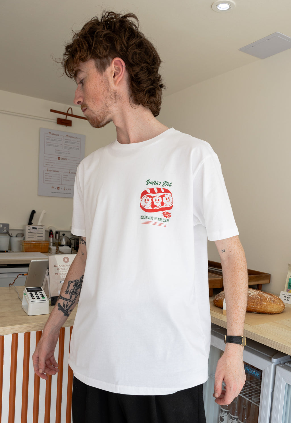 Model wears small front meatball subs food merch logo printed tshirt in white
