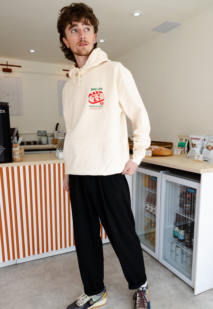 Model wears small logo print of meatball sub in vanilla hoodie