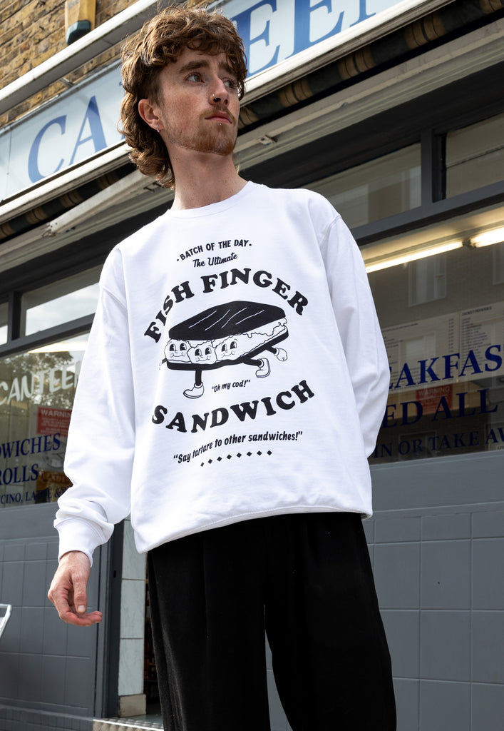 model wears white sweatshirt with fish finger sandwich character print