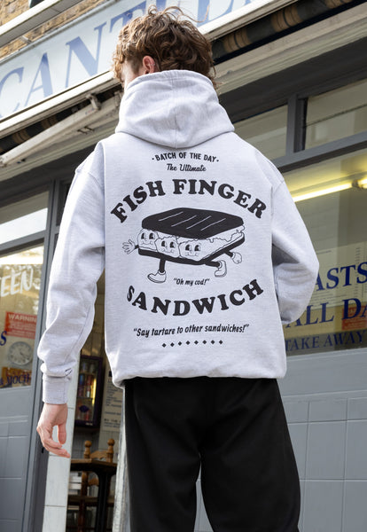 Model wears large back print fish finger character slogan hoodie in grey