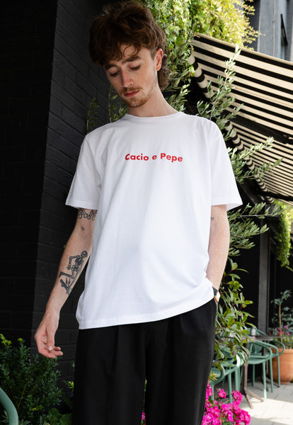 male model wears white t shirt with cacio e pepe pasta slogan print