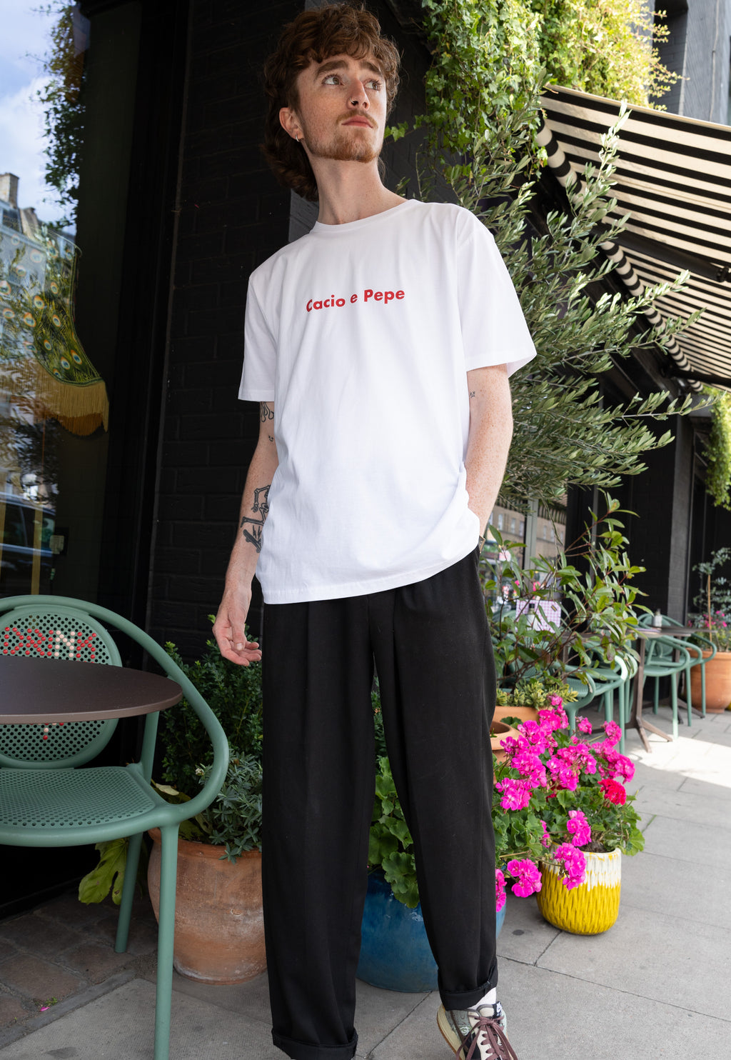male model wears white t shirt with cacio e pepe pasta slogan print
