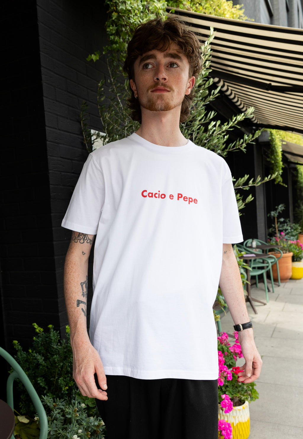 male model wears white t shirt with cacio e pepe pasta slogan print