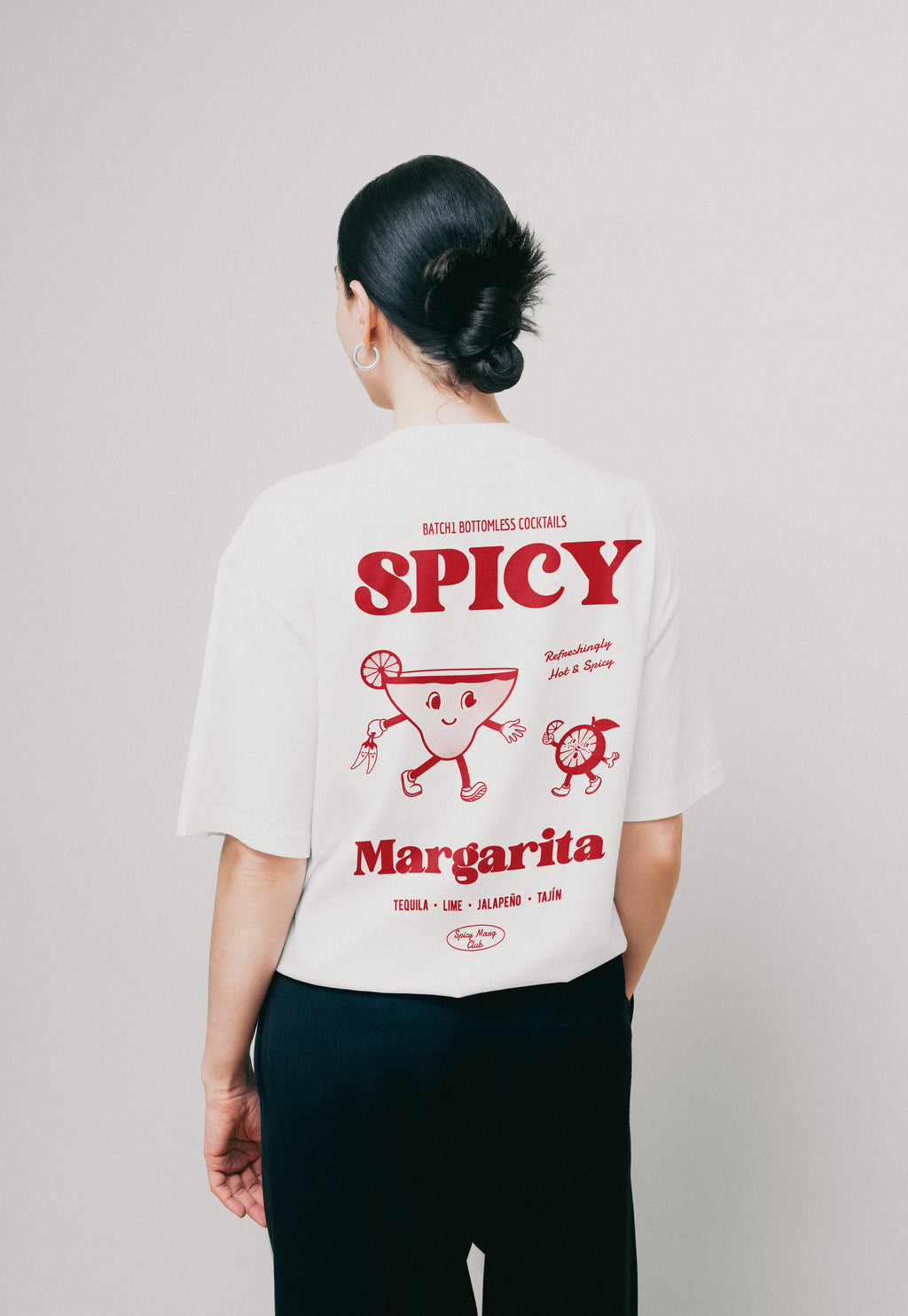 Person wearing a white t-shirt with red spicy margarita cocktail print