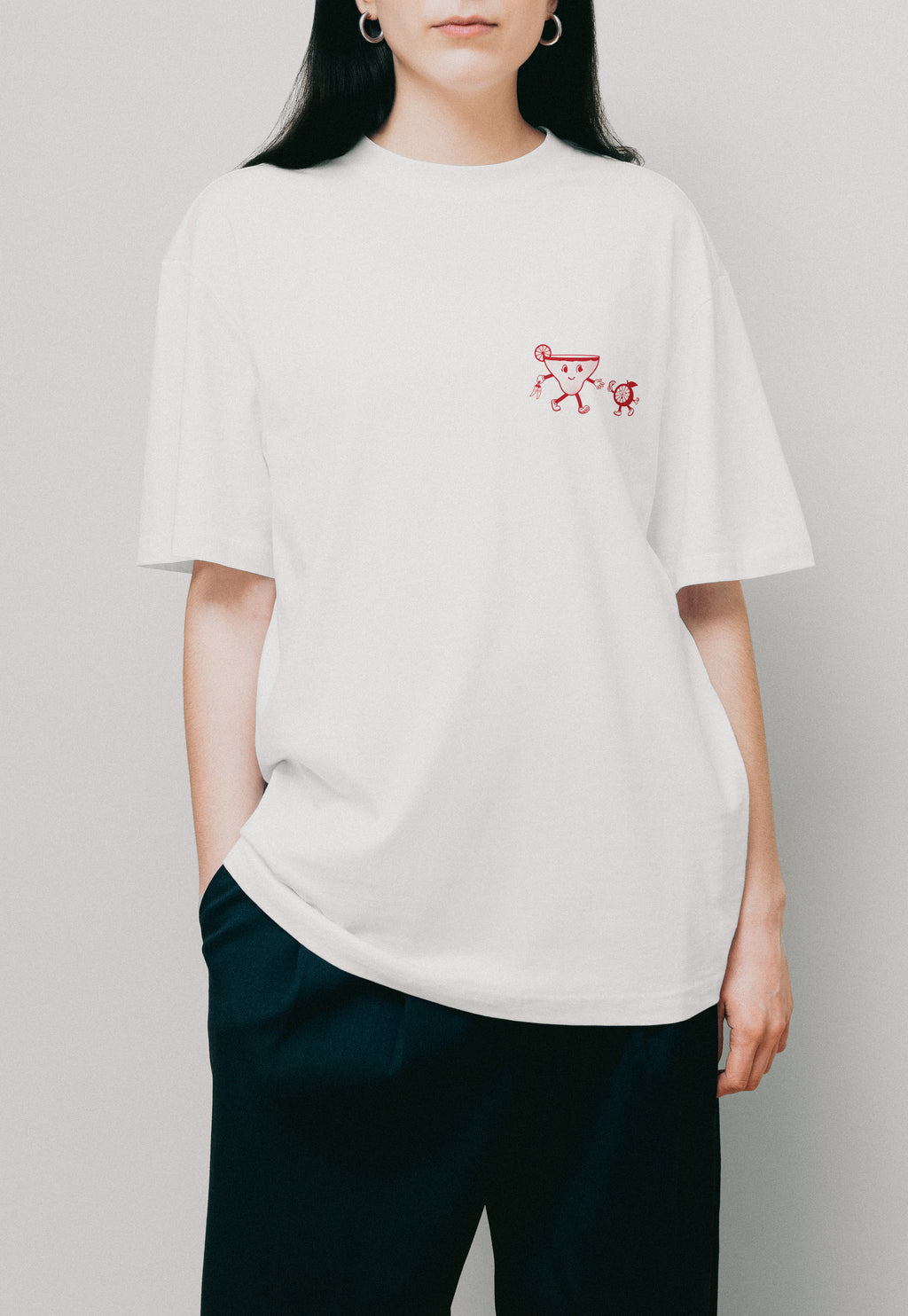 Model wearing a white t-shirt with a small spicy margarita logo on front