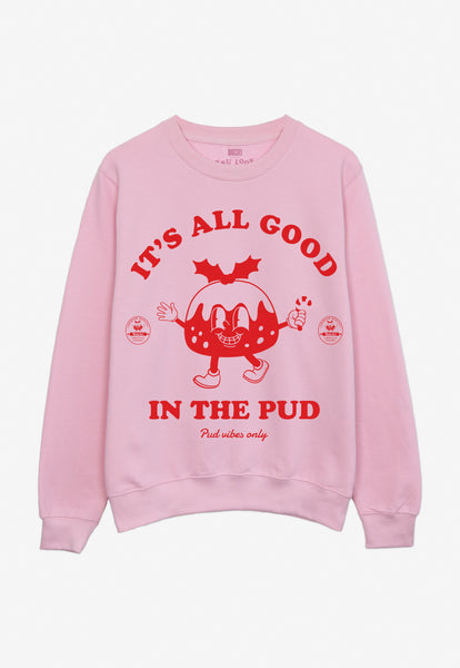 pink christmas jumper with pudding character graphic and fun festive slogan in red print