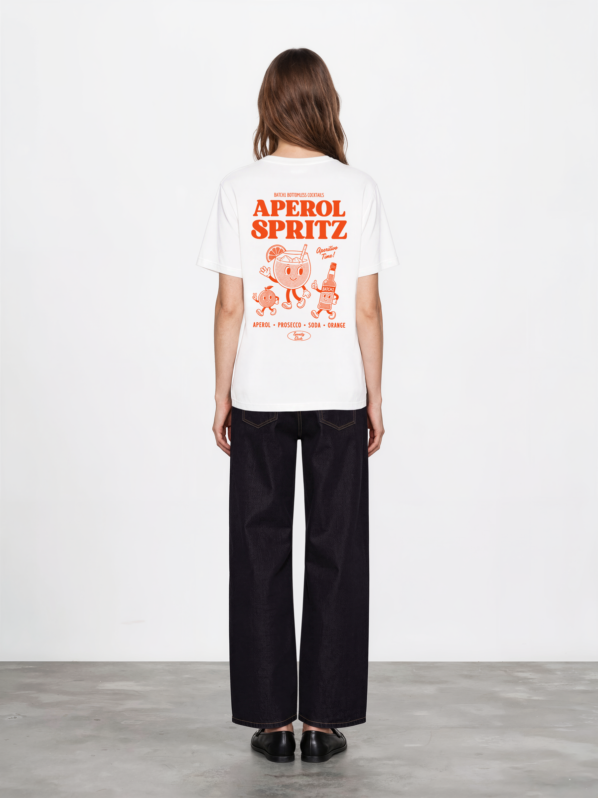 Aperol Spritz white T-shirt, female model back, showing the larger orange Aperol Spritz cocktail design on the back