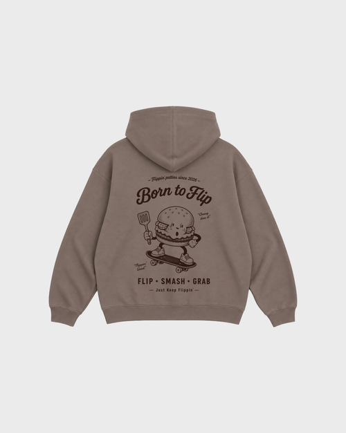 Back flat lay of the Born to Flip taupe oversized hoodie with a large brown skateboarding burger graphic beneath the hood.