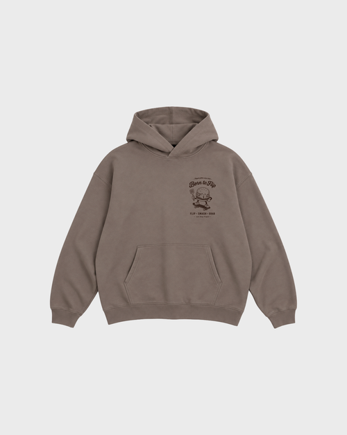 Front flat lay of the Born to Flip taupe oversized hoodie with brown burger artwork on the left chest.