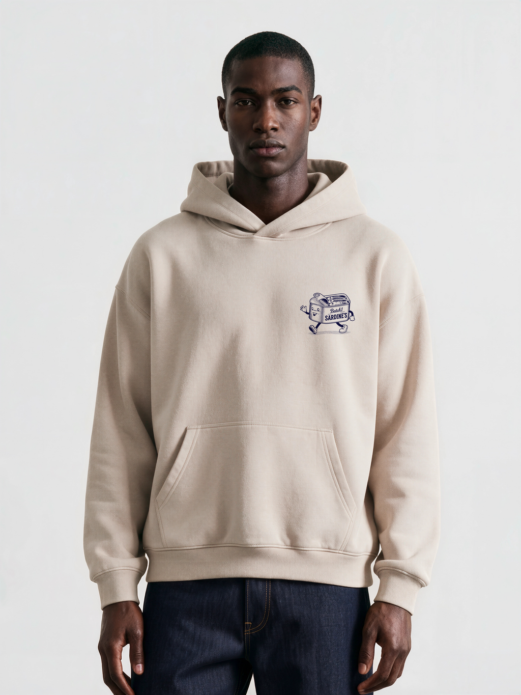 Brine and Dandy stone hoodie, front male model, showing a small navy sardine-tin chest print