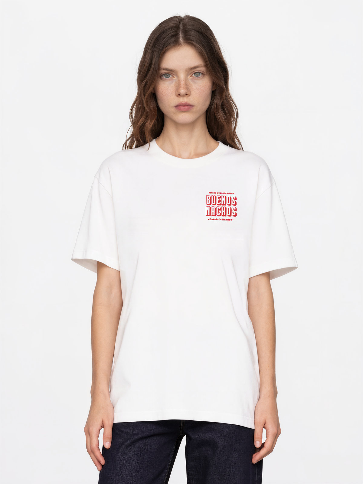 Female model wearing the Buenos Nachos white T-shirt, front view showing the red left-chest print.