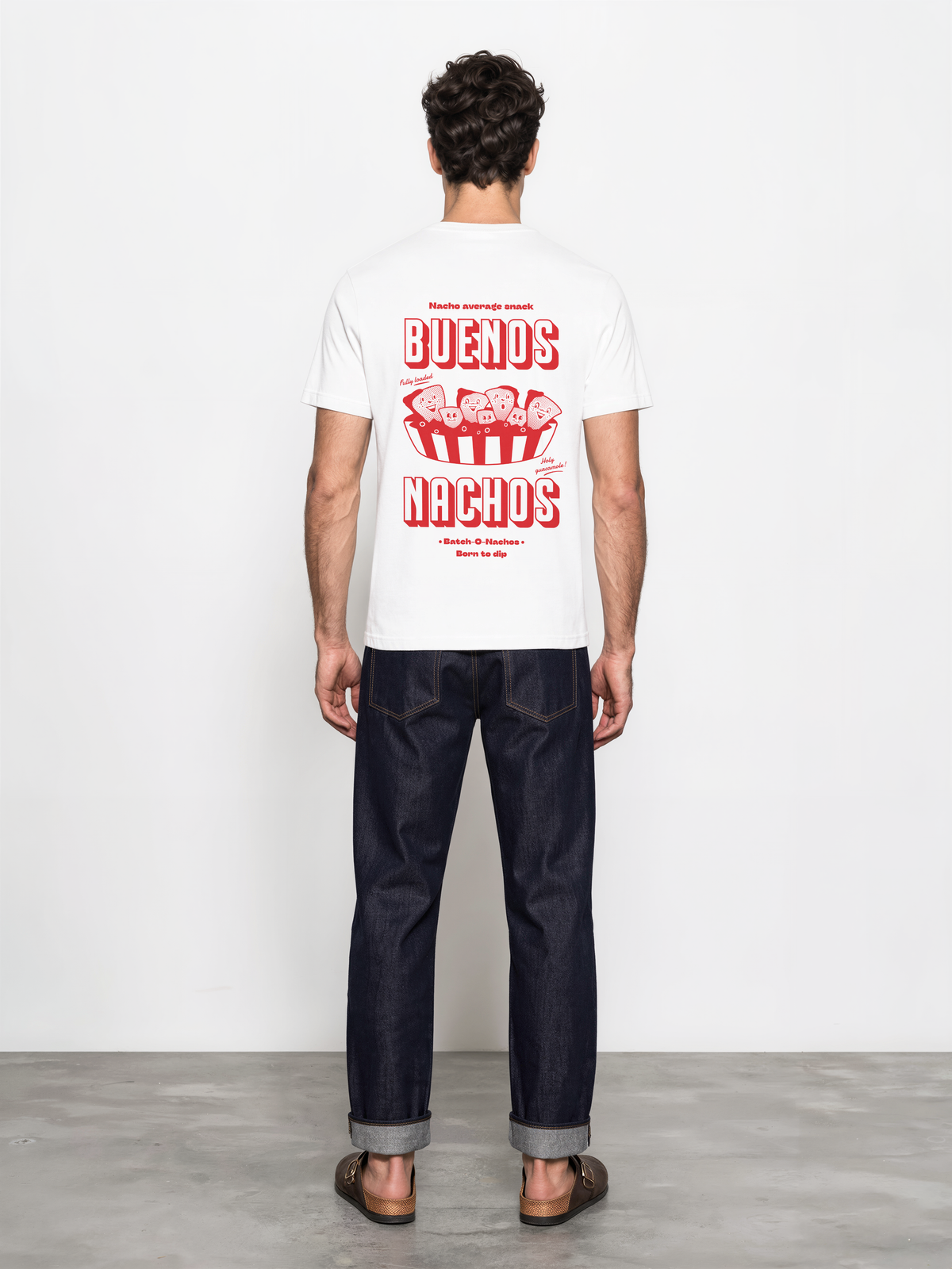 Male model wearing the Buenos Nachos white T-shirt, back view showing the red nacho illustration and lettering on the back.
