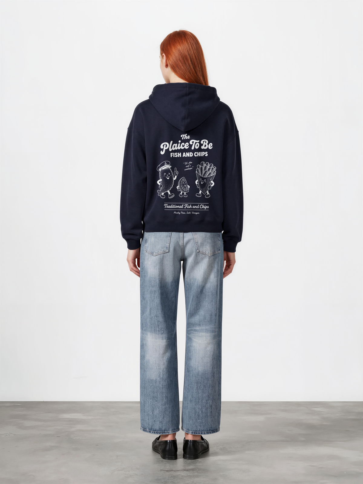 Navy Fish and Chips The Plaice To Be hoodie, female model back view with white large back graphic