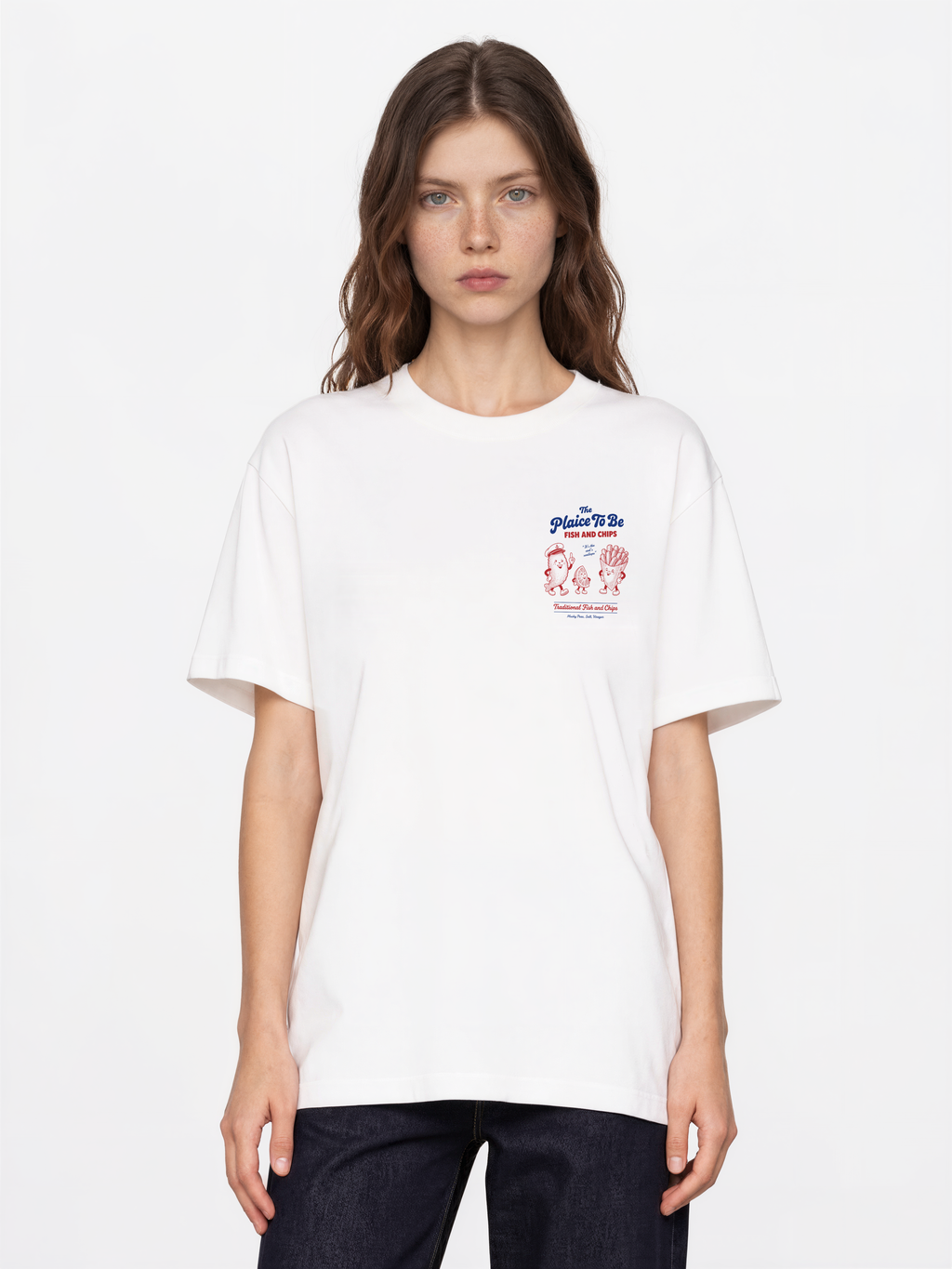 White Fish and Chips The Plaice To Be t-shirt, female model front view with red and blue small left-chest graphic