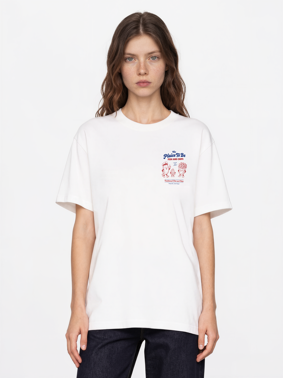 White Fish and Chips The Plaice To Be t-shirt, female model front view with red and blue small left-chest graphic