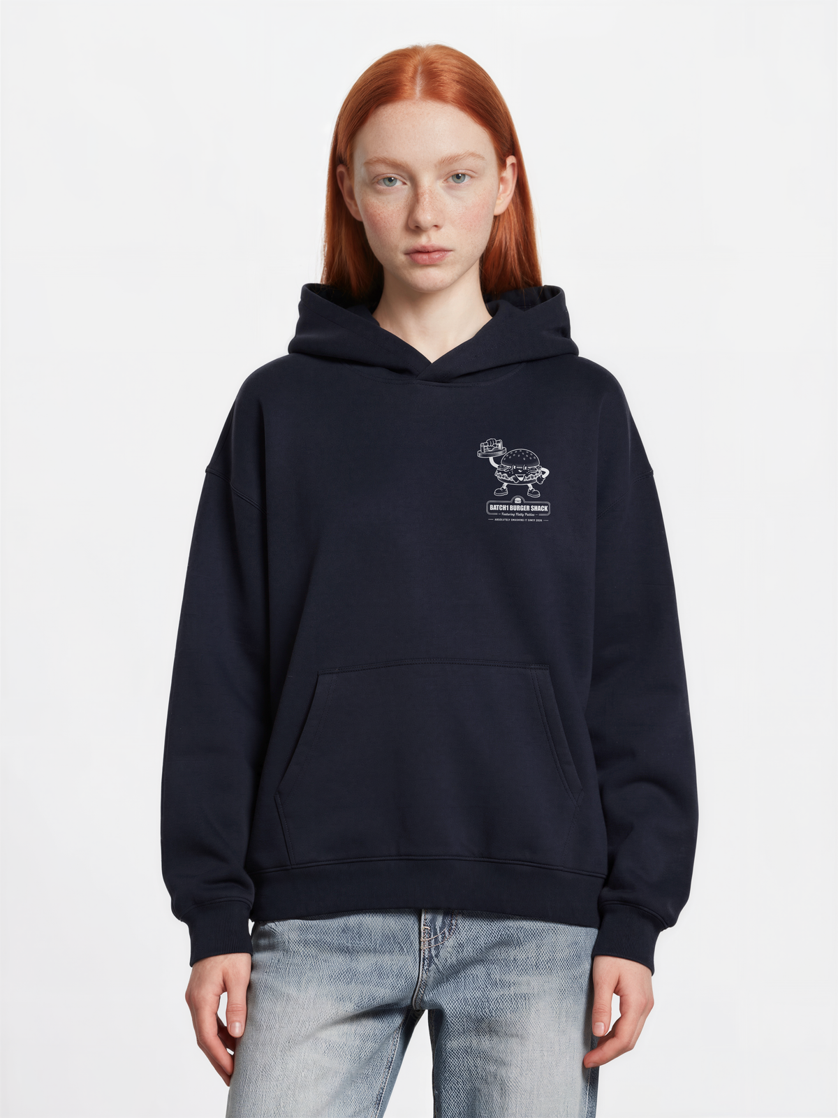 Female model wearing the Get Smashed navy oversized hoodie, front view showing the small white burger graphic on the left chest.