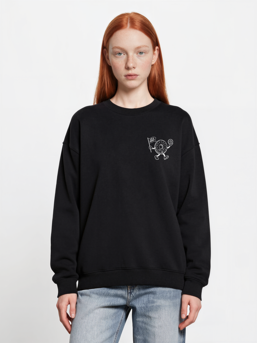 Glazy Days black sweatshirt, front female model, showing a small white doughnut character chest print