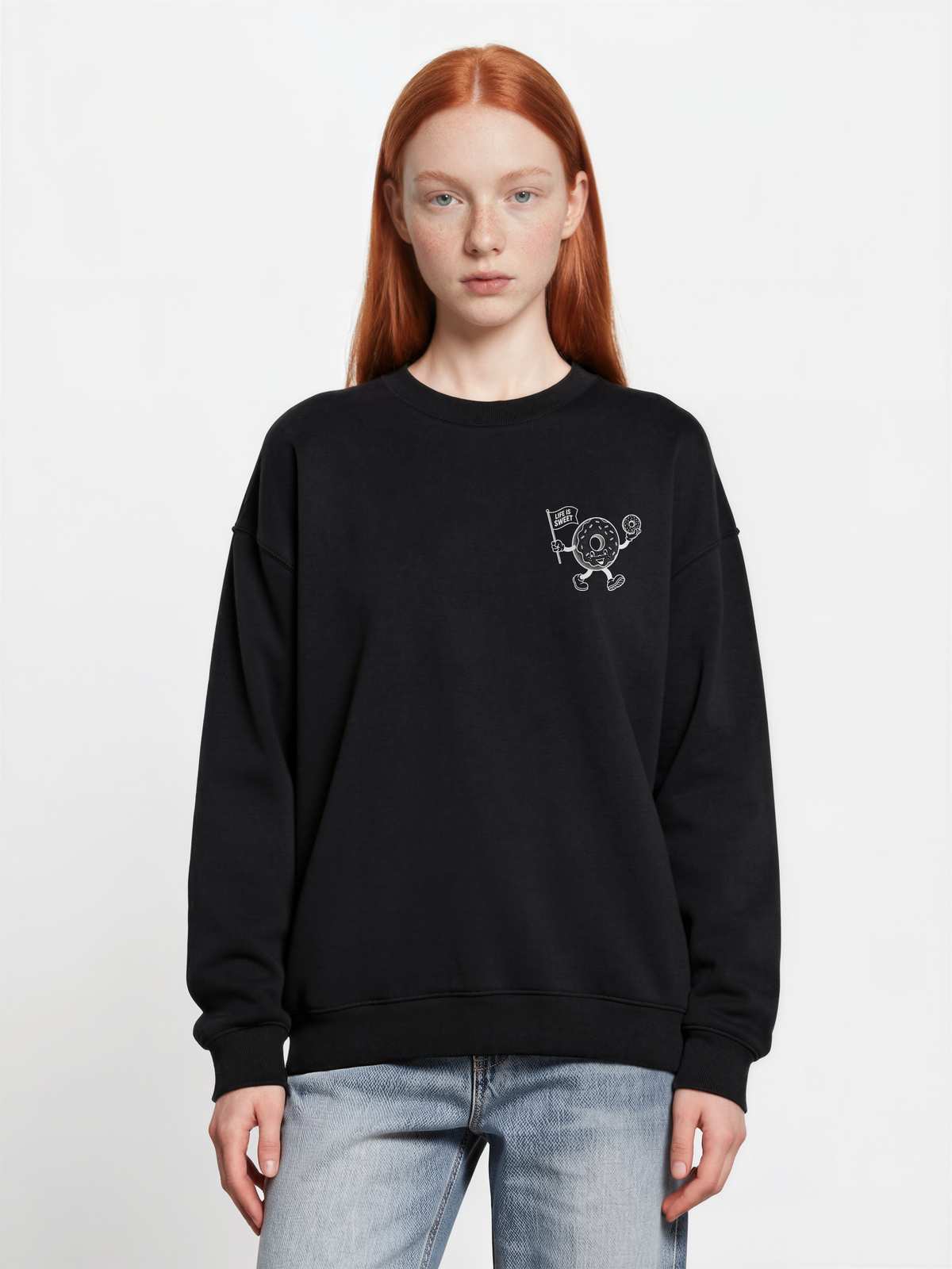 Glazy Days black sweatshirt, front female model, showing a small white doughnut character chest print