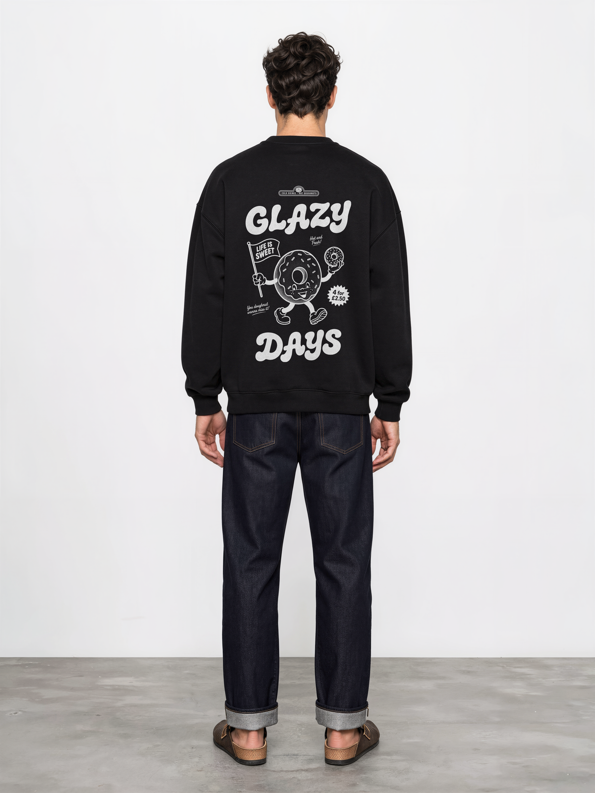 Glazy Days black sweatshirt, back male model, showing the larger white Glazy Days doughnut design on the back