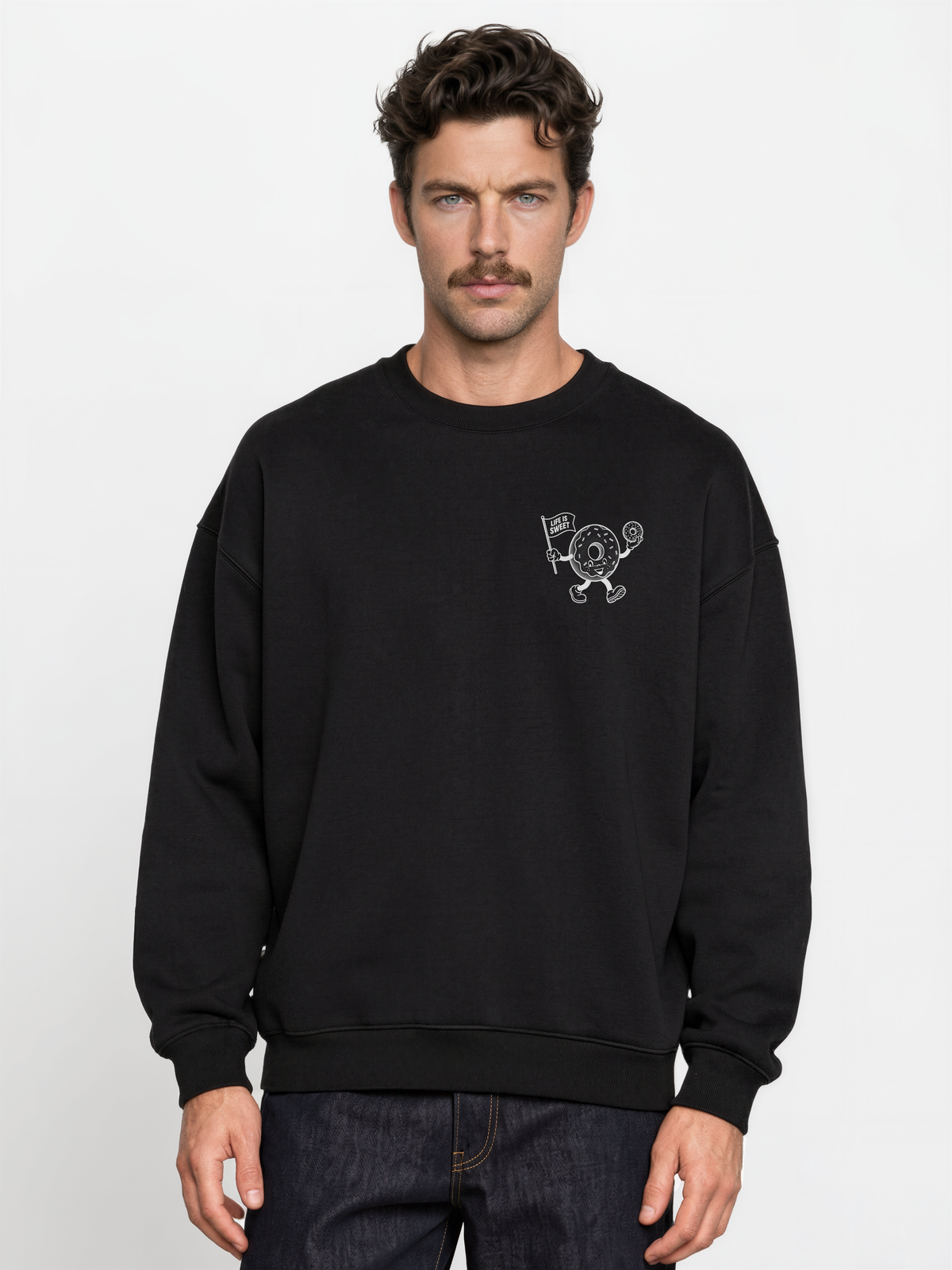 Glazy Days black sweatshirt, front male model, showing a small white doughnut character chest print