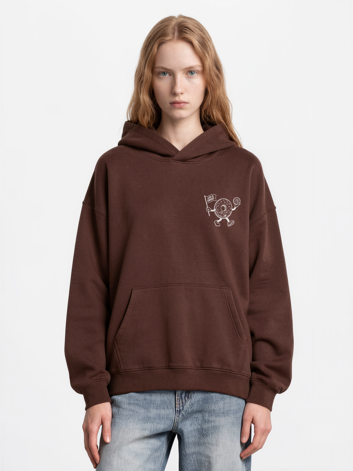 Glazy Days chocolate hoodie, front female model, showing a small white doughnut character chest print