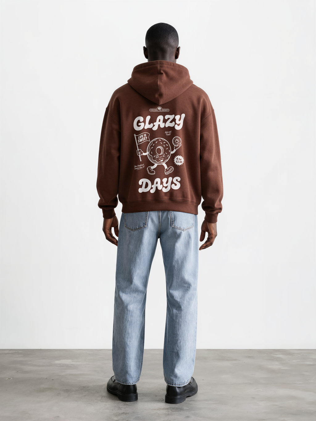 Glazy Days chocolate hoodie, back male model, showing the larger white Glazy Days doughnut design on the back
