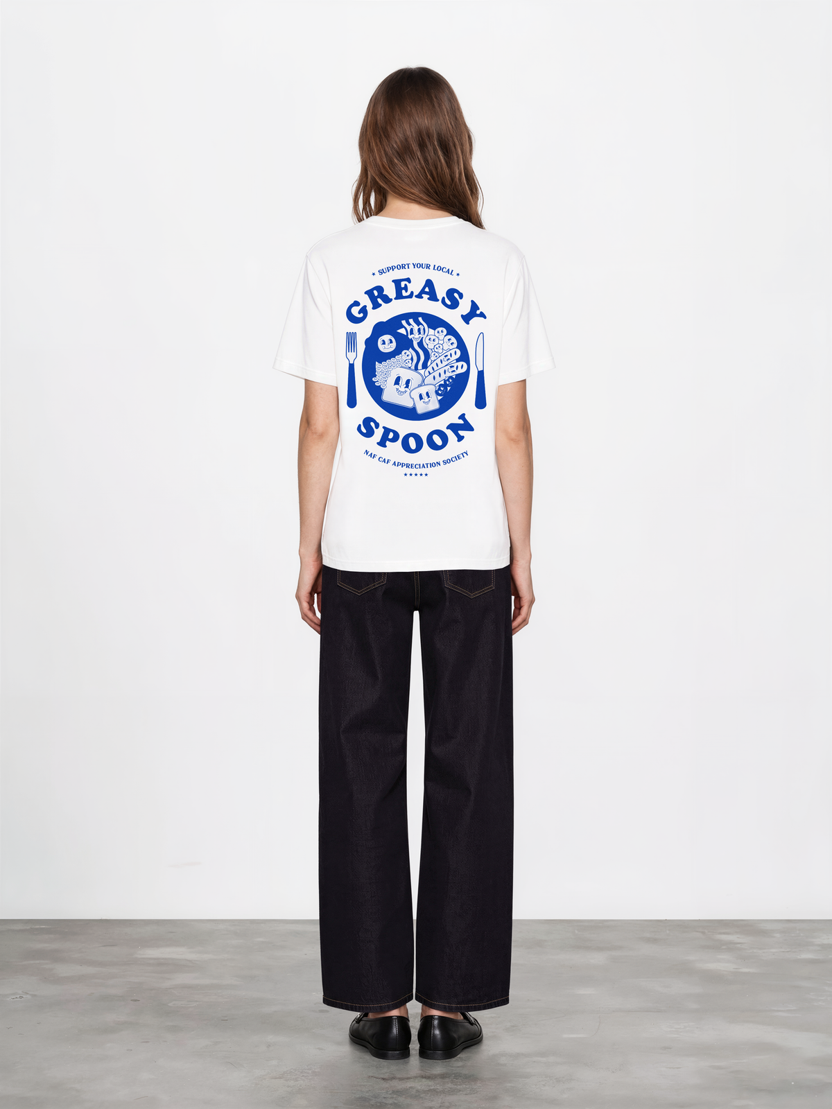 Greasy Spoon white T-shirt, female back model, showing a larger blue Greasy Spoon breakfast graphic across the back
