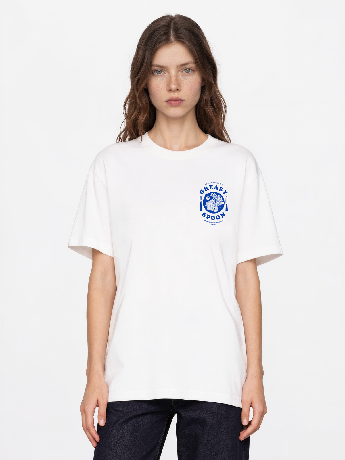 Greasy Spoon white T-shirt, female front model, showing a small blue Greasy Spoon breakfast graphic on the left chest
