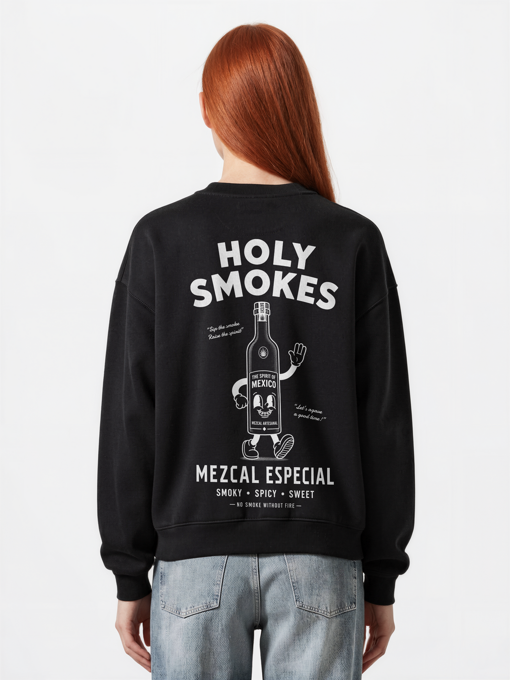 Female model wearing the black Holy Smokes oversized sweatshirt, showing the large white Holy Smokes mezcal bottle screen print on the back