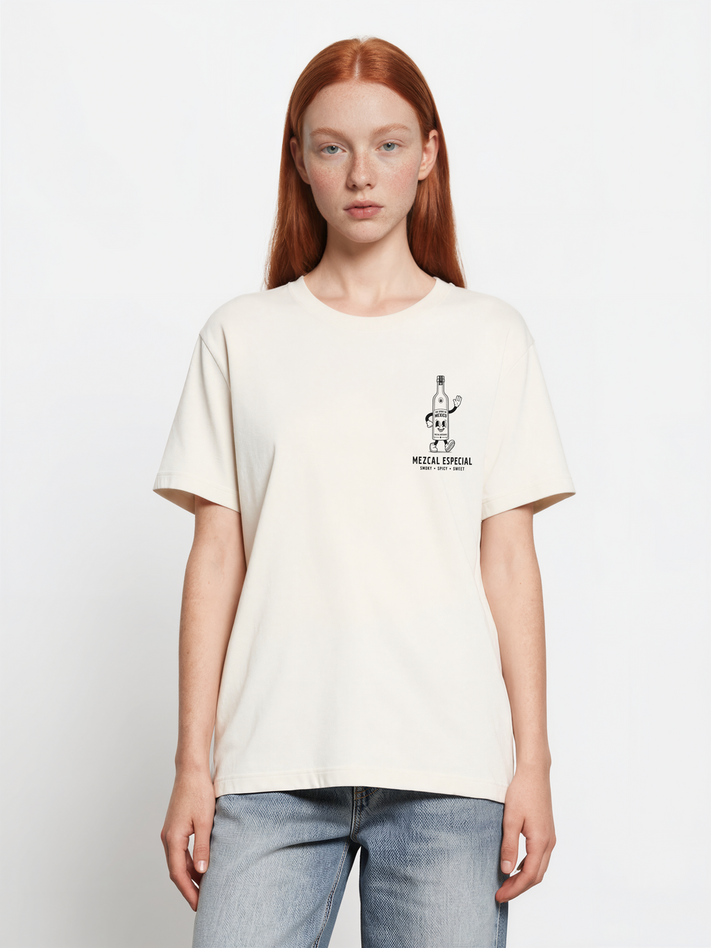 Female model wearing the ivory Holy Smokes T-shirt, showing the small black mezcal bottle print on the left chest
