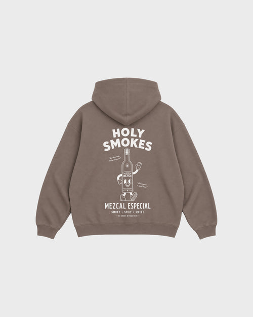 Back flat lay of the mocha Holy Smokes oversized hoodie with white mezcal bottle artwork and Holy Smokes lettering beneath the hood