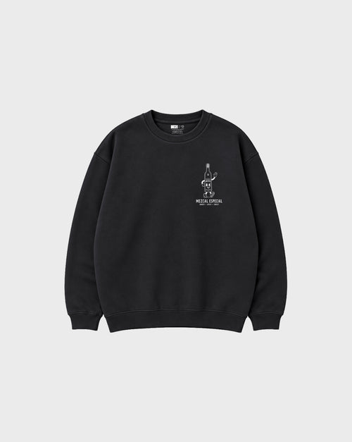 Front flat lay of the black Holy Smokes oversized sweatshirt with a white mezcal bottle graphic on the left chest