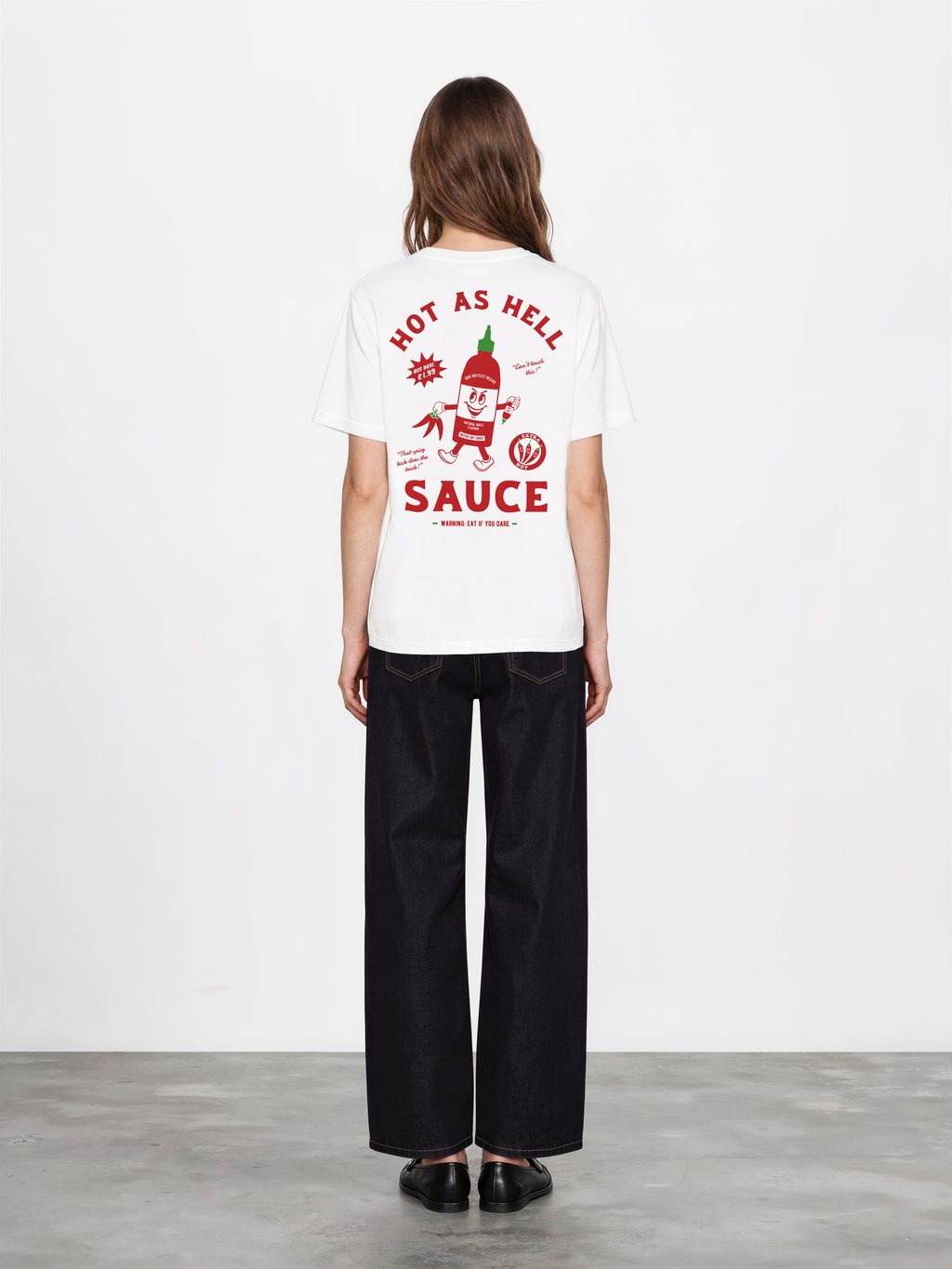 Hot Sauce white T-shirt, female back model, showing the larger red and green Hot as Hell Sauce graphic across the back