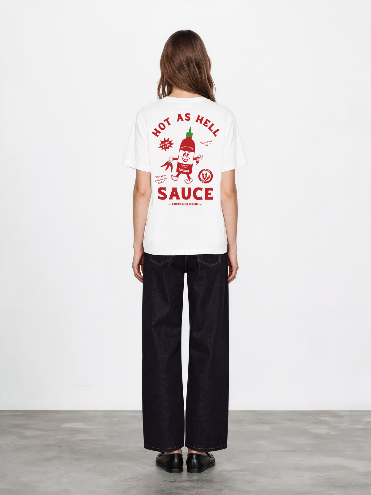 Hot Sauce white T-shirt, female back model, showing the larger red and green Hot as Hell Sauce graphic across the back