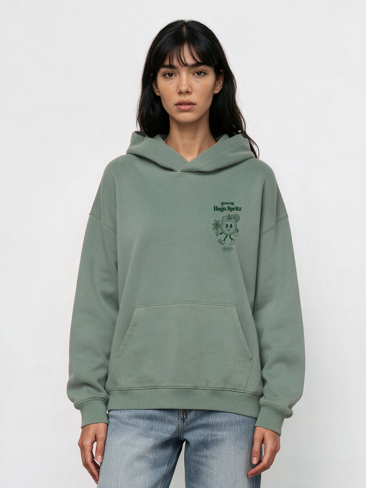 Female model wearing the Hugo Spritz Pine oversized hoodie, showing the green left chest print
